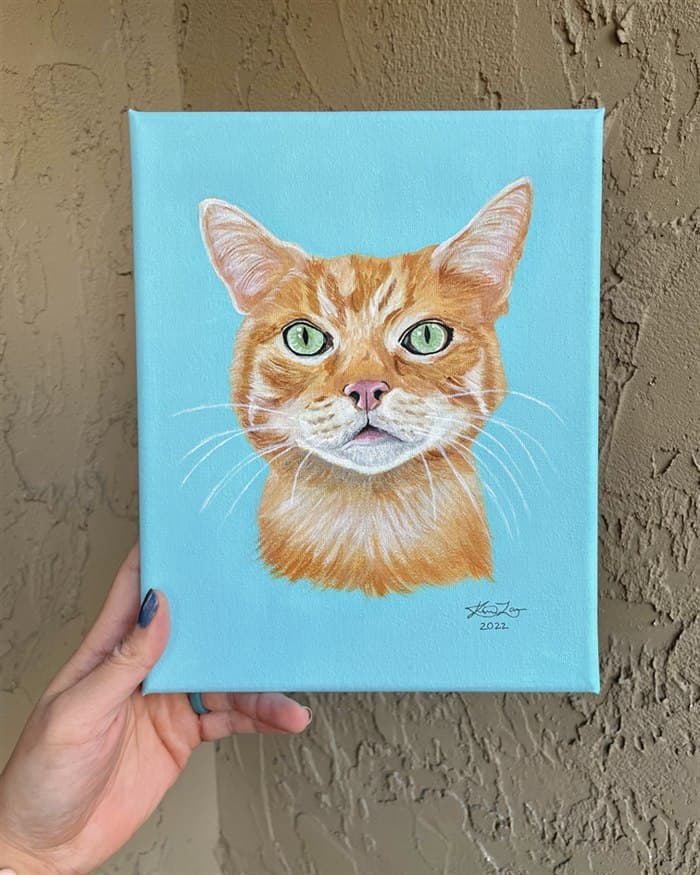 Hand-painted orange tabby cat portrait on canvas with a light blue background